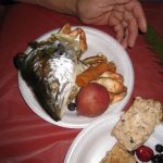 fish head, vegetables, and potatoes on a plate